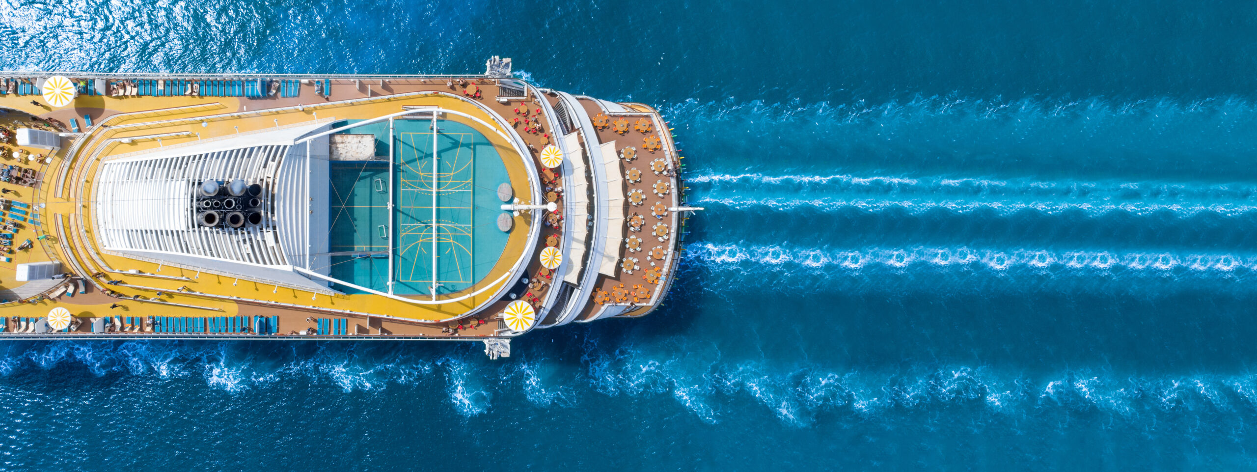 Aerial view of a cruise ship sailing on blue water Aerial view of a cruise ship sailing on blue water