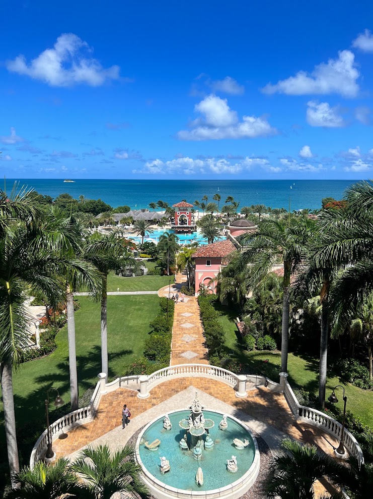 Fountain courtyard and tropical gardens leading to the sea at a Caribbean all-inclusive resort