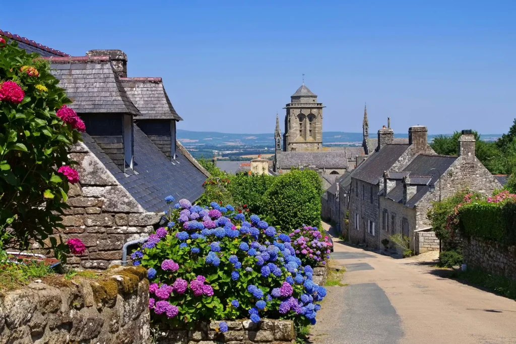 A flower-lined street in Locronan village, Brittany