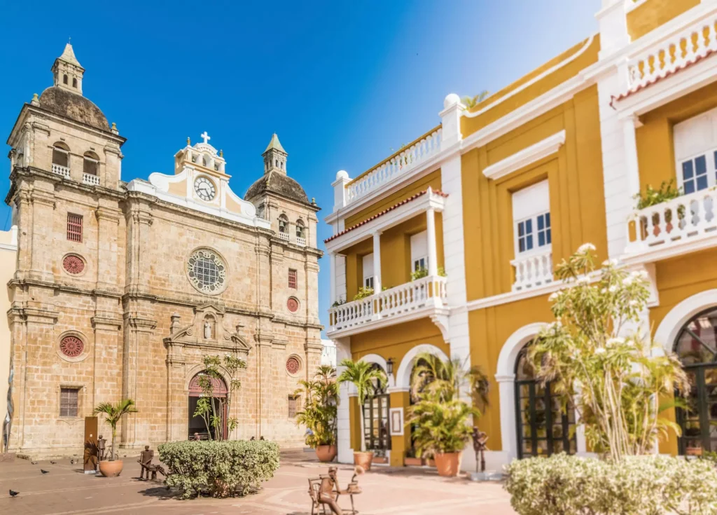 A vibrant view of historic architecture in Cartagena, Colombia, showcasing a beautiful church and colourful buildings