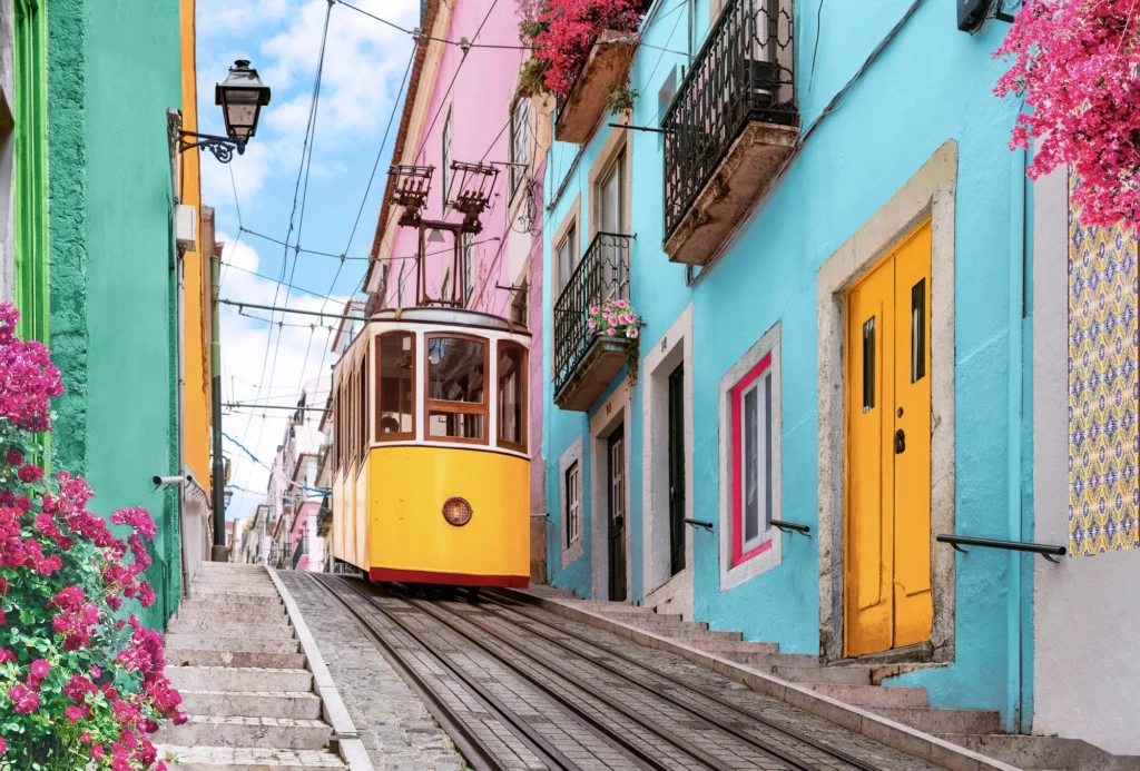 A yellow tram on a colorful Lisbon street