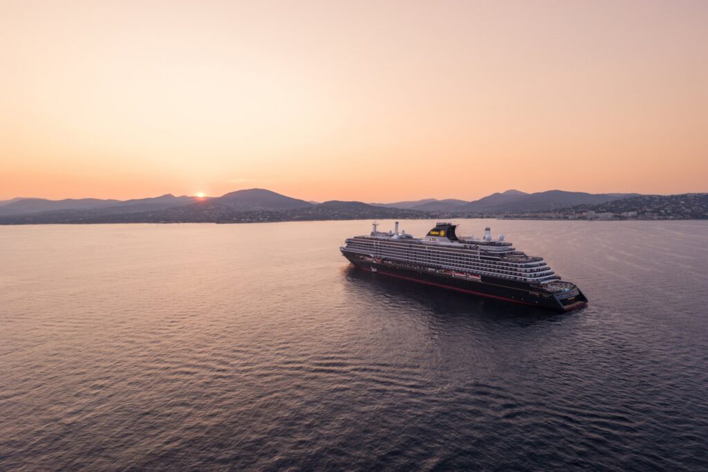 Aerial view of Explora III at sea at sunset
