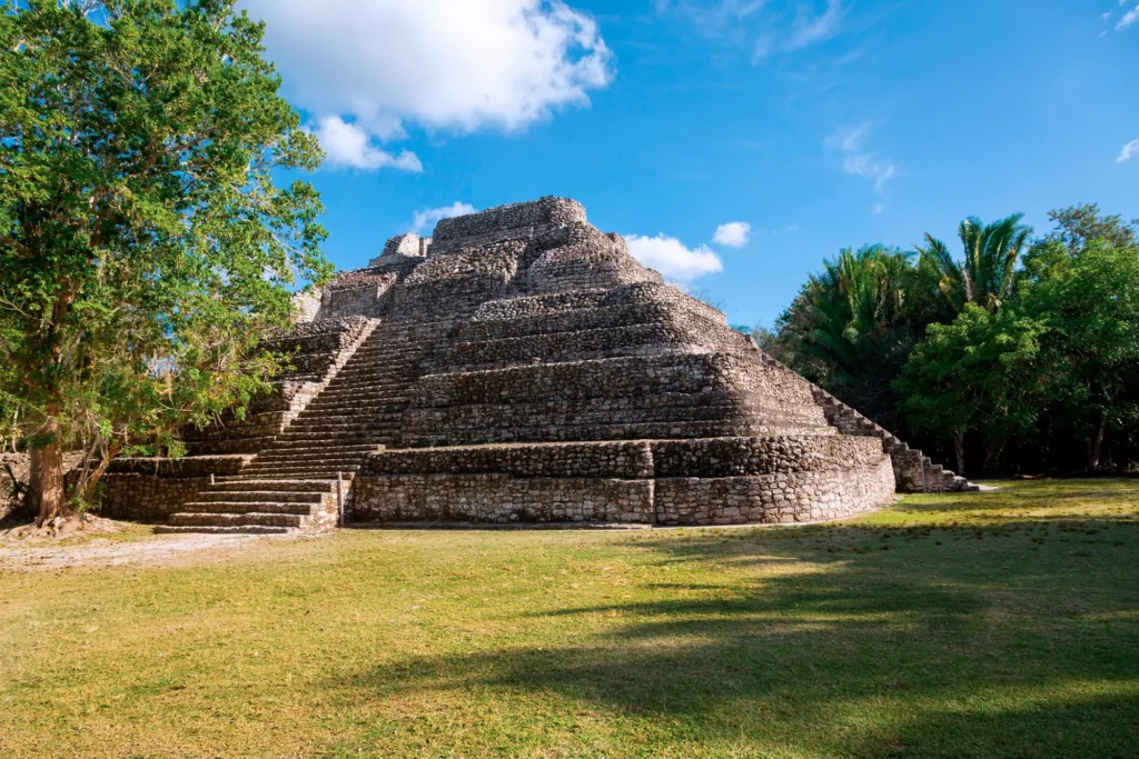 Ancient pyramid at the Chacchoben archaeological site surrounded by lush greenery in Mexico