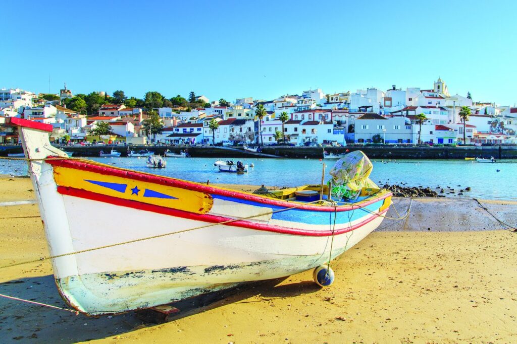 Colorful fishing boat on the beach in Portimão, Portugal