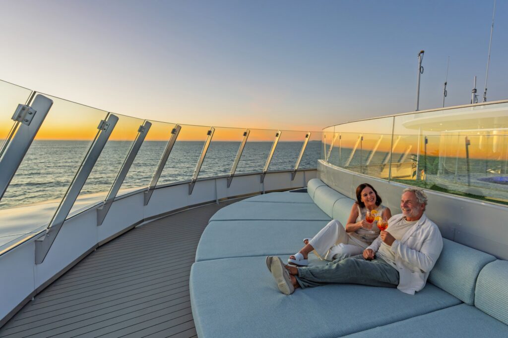 Couple relaxing on the Sky Deck aboard Scenic Eclipse II