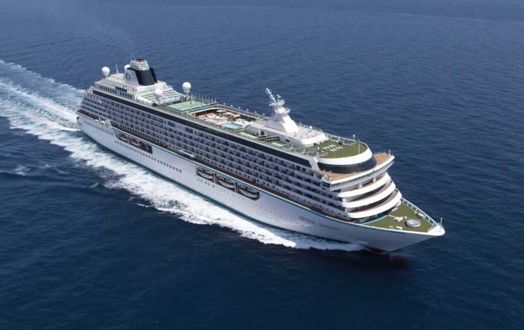 Aerial view of Crystal Serenity cruising across deep blue open ocean