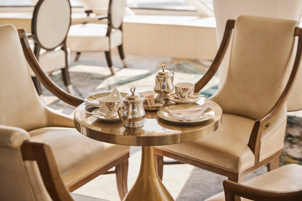 Palm Court lounge seating by the windows aboard Crystal
