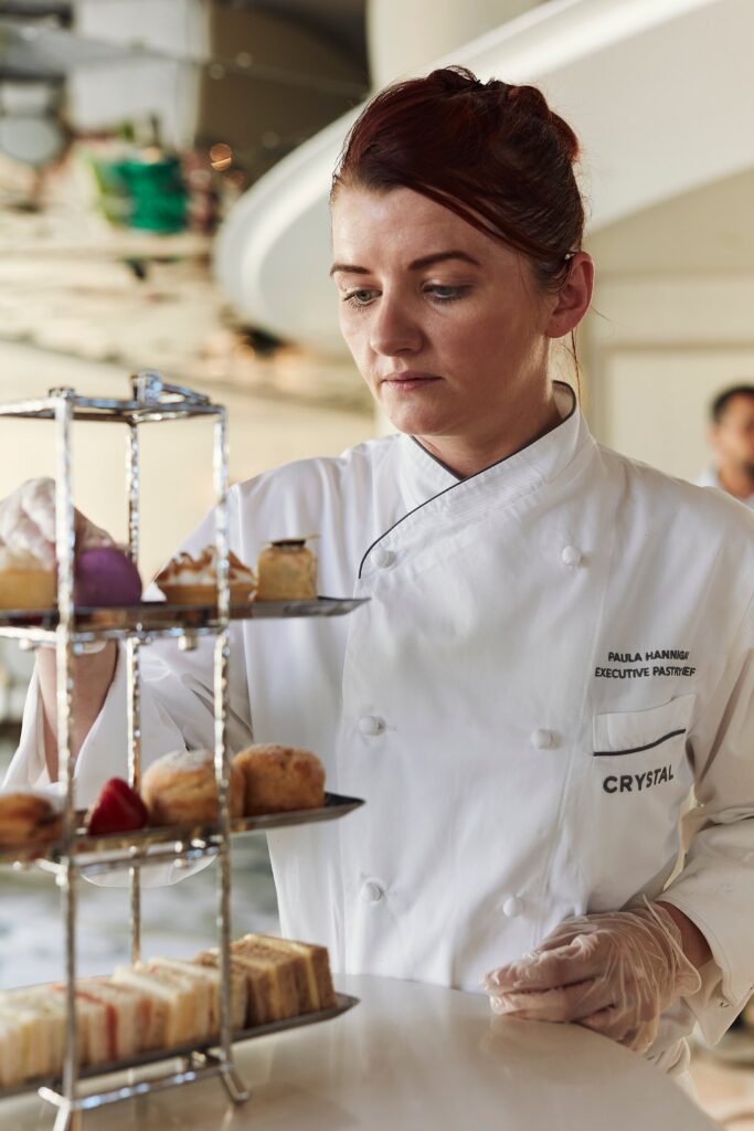 Pastry chef presenting an afternoon tea tower aboard Crystal