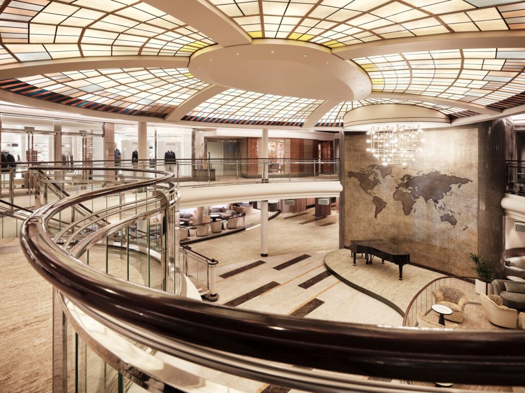 Refurbished Crystal Symphony lounge with curved seating and a bar