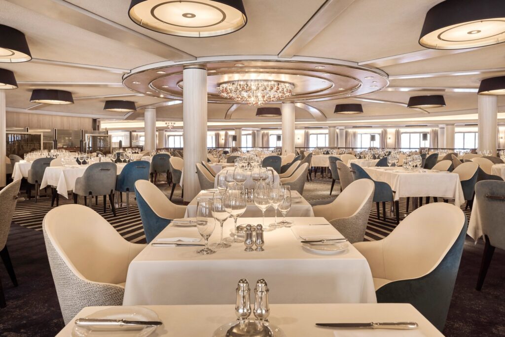 Waterside restaurant dining room with ocean-view windows aboard Crystal