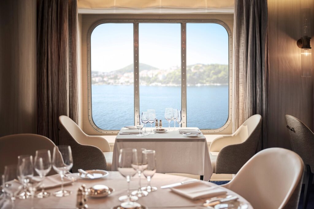 Window-side table set for dinner in Waterside aboard Crystal