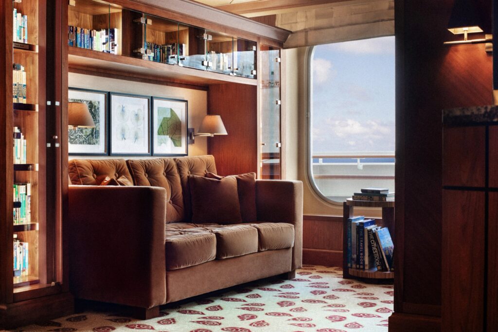 Wood-paneled library with comfortable seating aboard Crystal