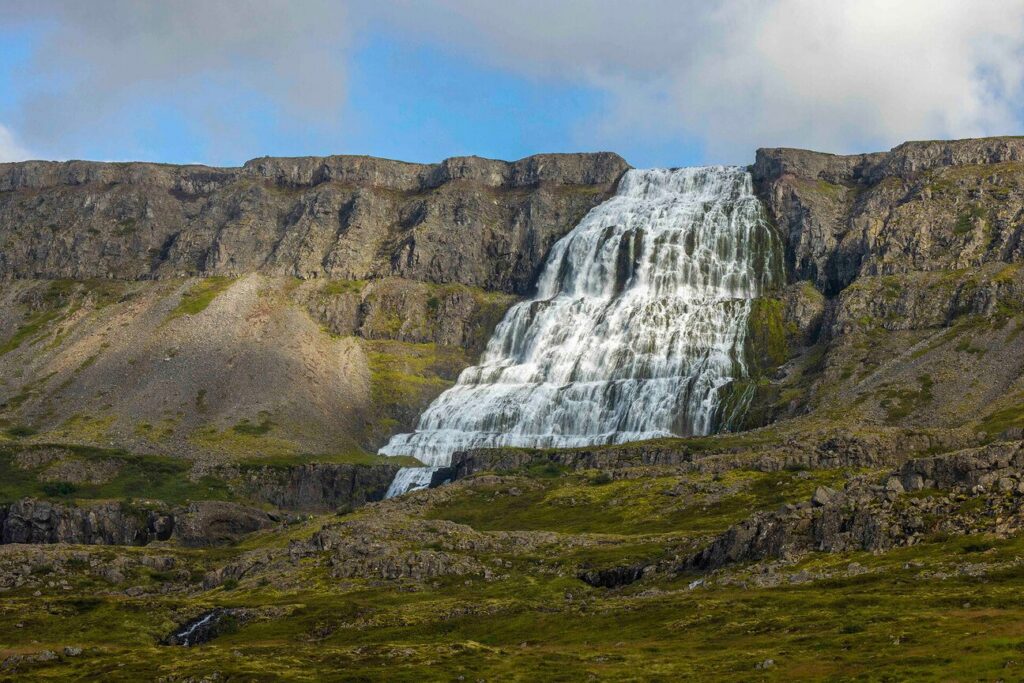 Dynjandi waterfall cascading down a hillside in Iceland