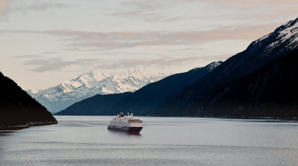 Explora III cruising past snowy mountains in Alaska