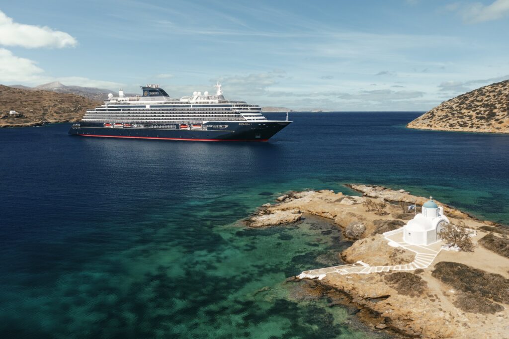 Explora Journeys ship near a rocky Mediterranean island