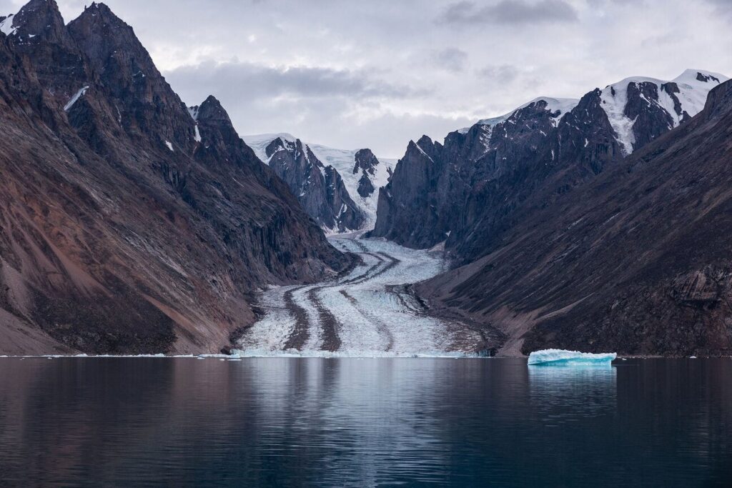 Glacier flowing into a remote Arctic fjord