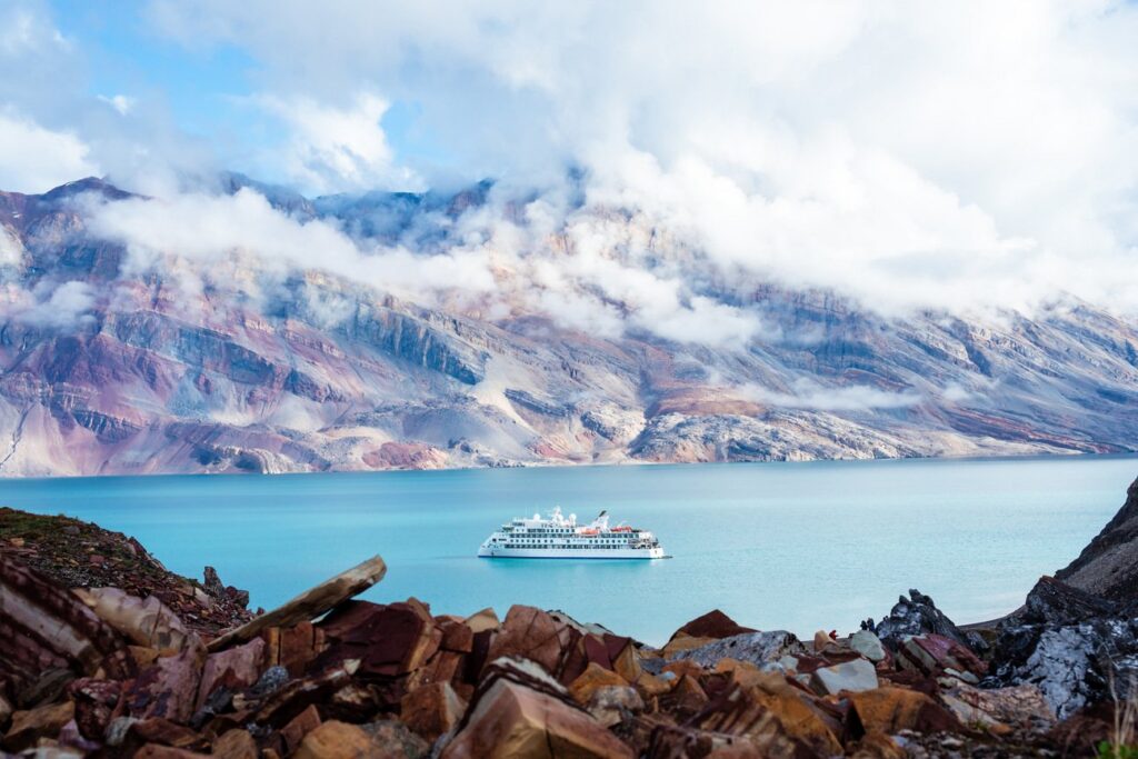 Greg Mortimer expedition ship below snowy polar mountains