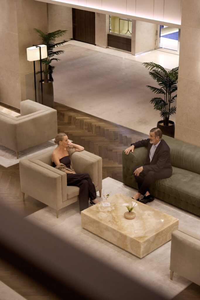 Guests relaxing in a lounge aboard Explora Journeys