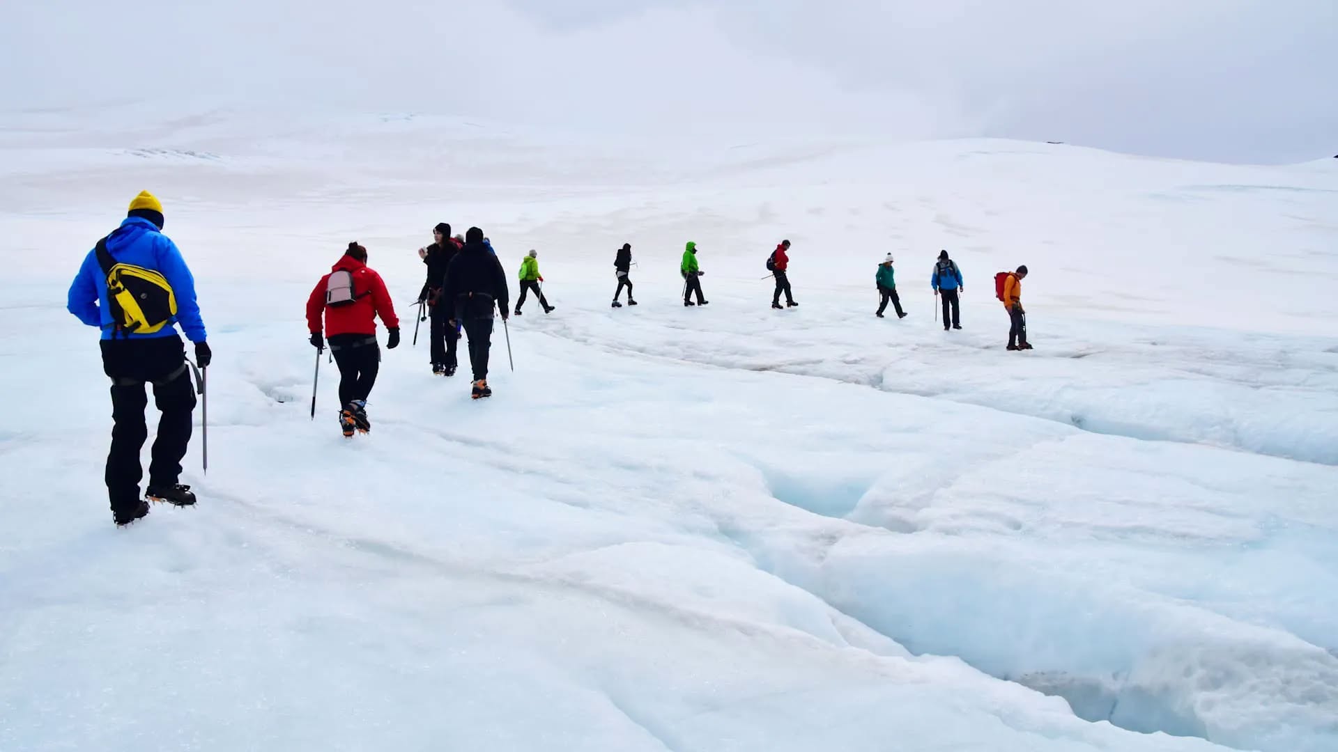 Group on a guided glacier hike across snow and ice