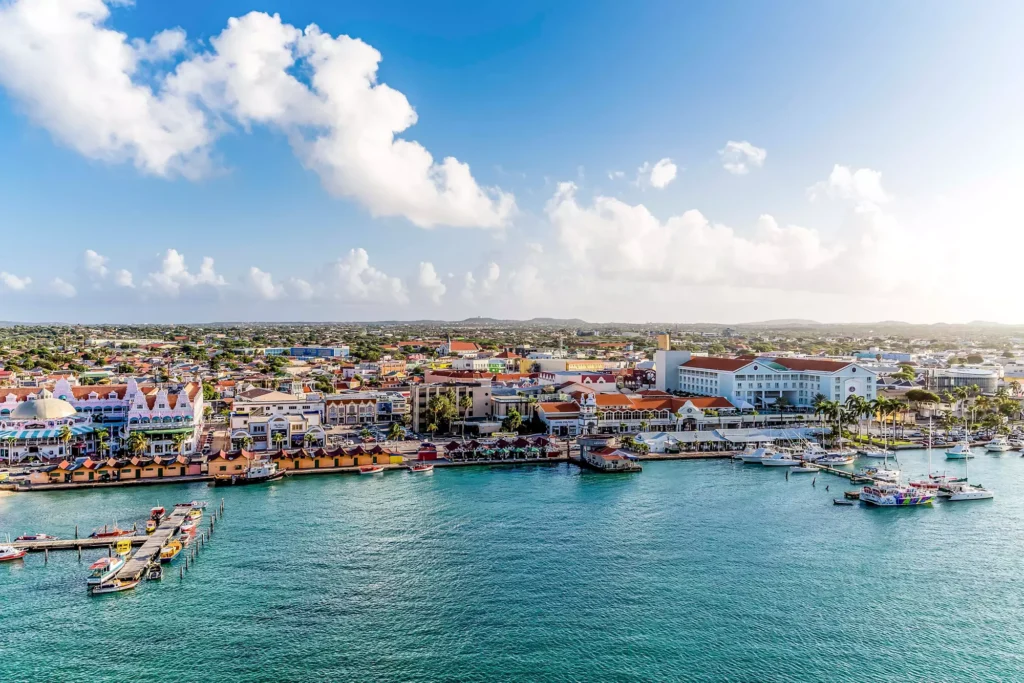 Oranjestad harbor with boats and colorful buildings in Aruba