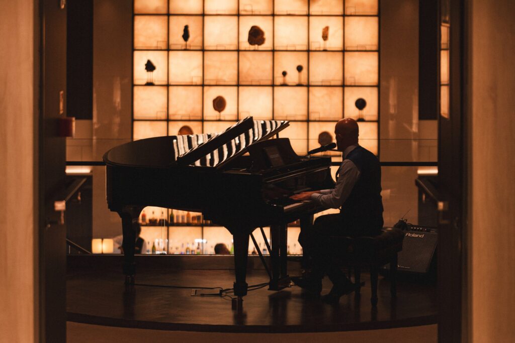 Pianist performing in a lounge aboard Explora Journeys