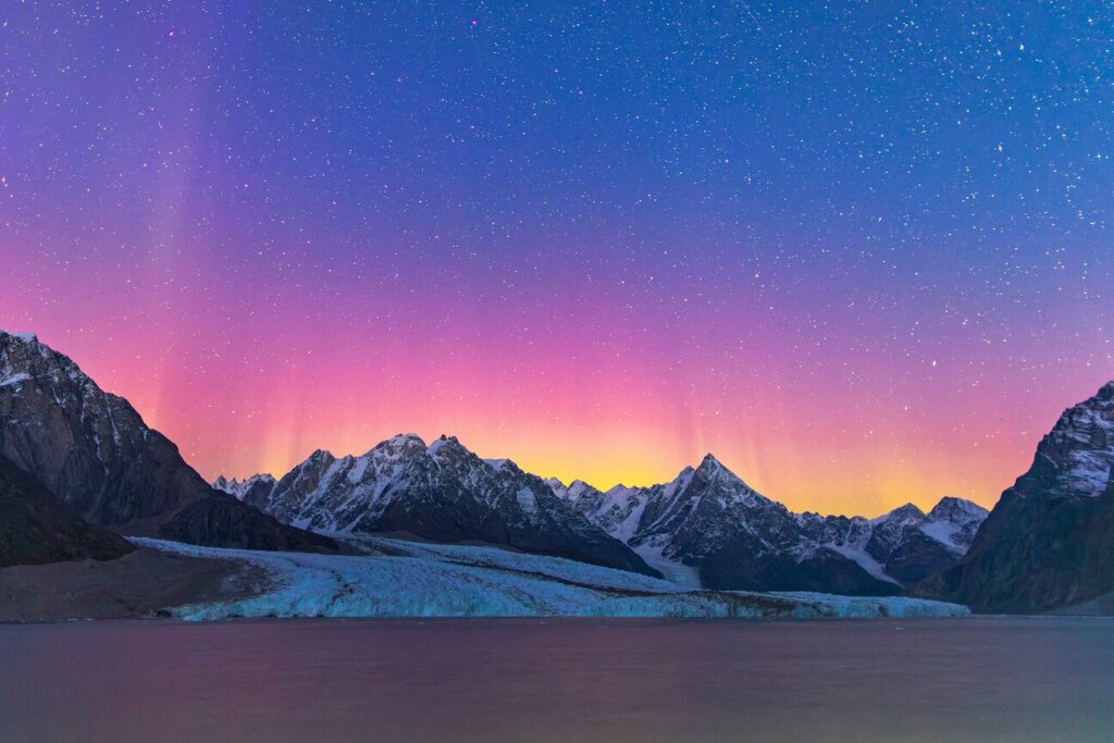 Pink alpenglow over snow-capped Arctic mountains