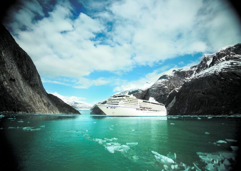 Regent Seven Seas Mariner cruising an Alaska fjord