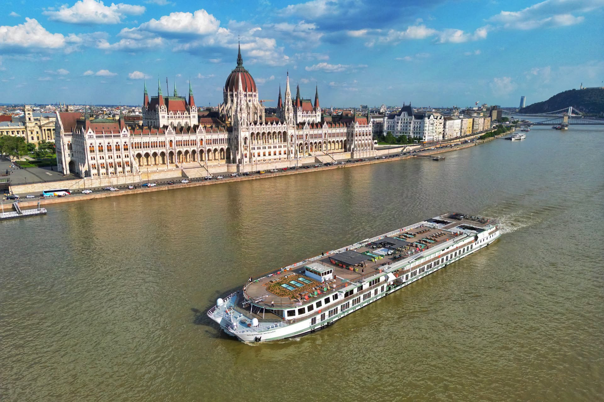 River cruise ship sailing past the Hungarian Parliament Building in Budapest on the Danube