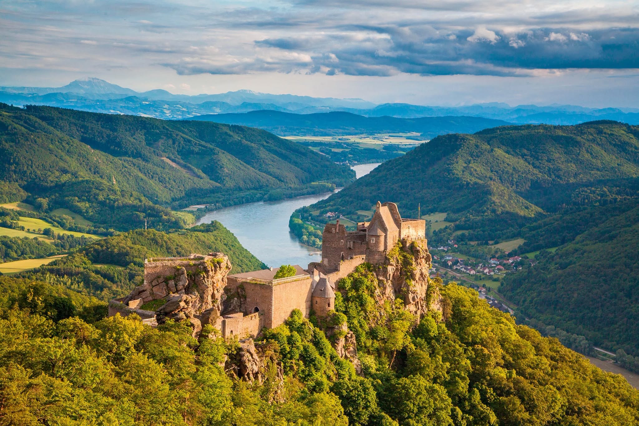 River valley with hilltop castle ruins seen on a European river cruise