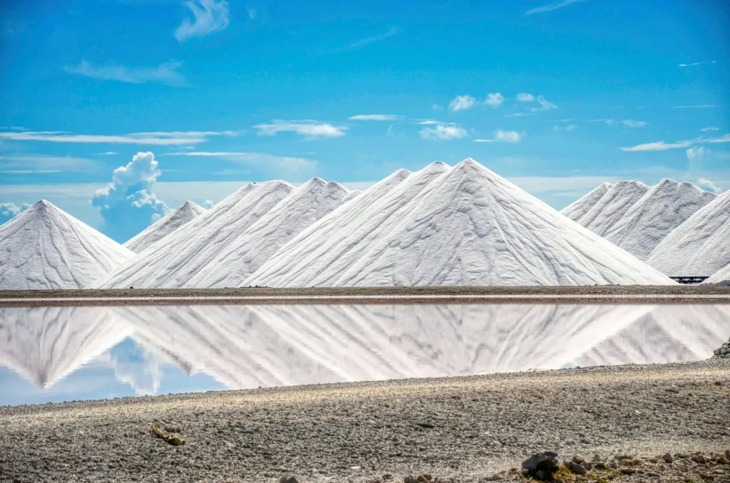 Salt pyramids reflecting a bright blue sky in Bonaire