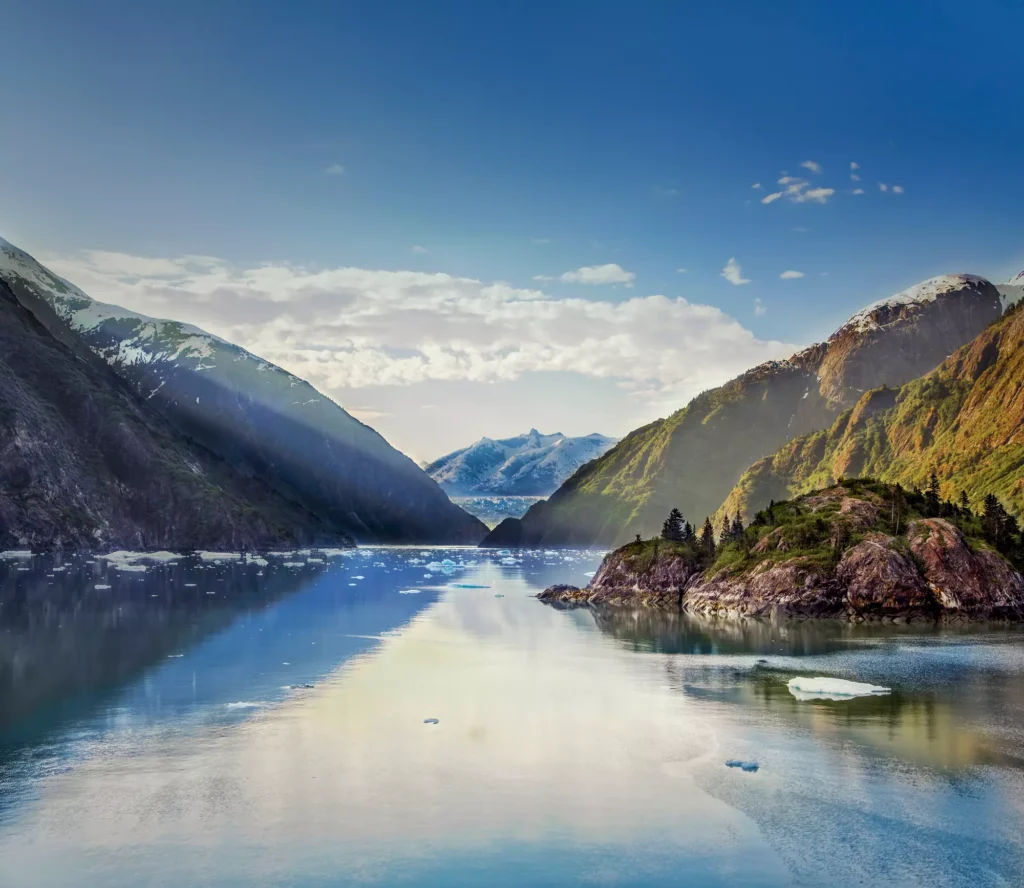 Serene lake surrounded by majestic mountains and glaciers in Tracy Arm, Alaska
