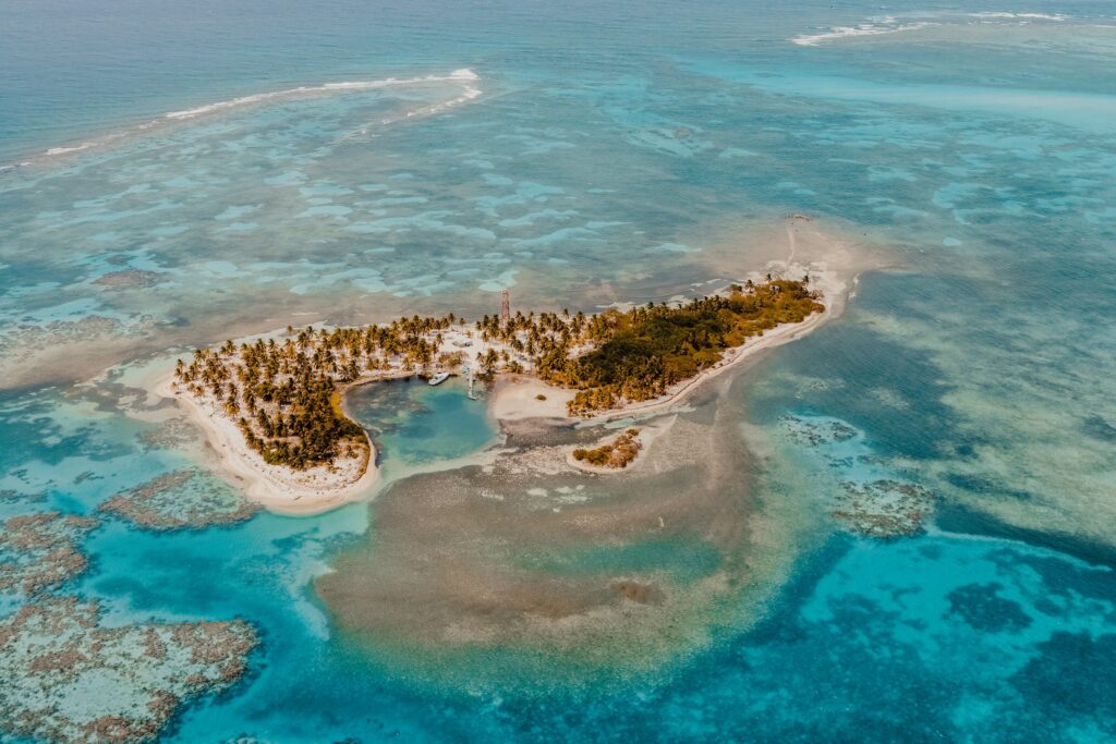 Small Caribbean island surrounded by coral reef