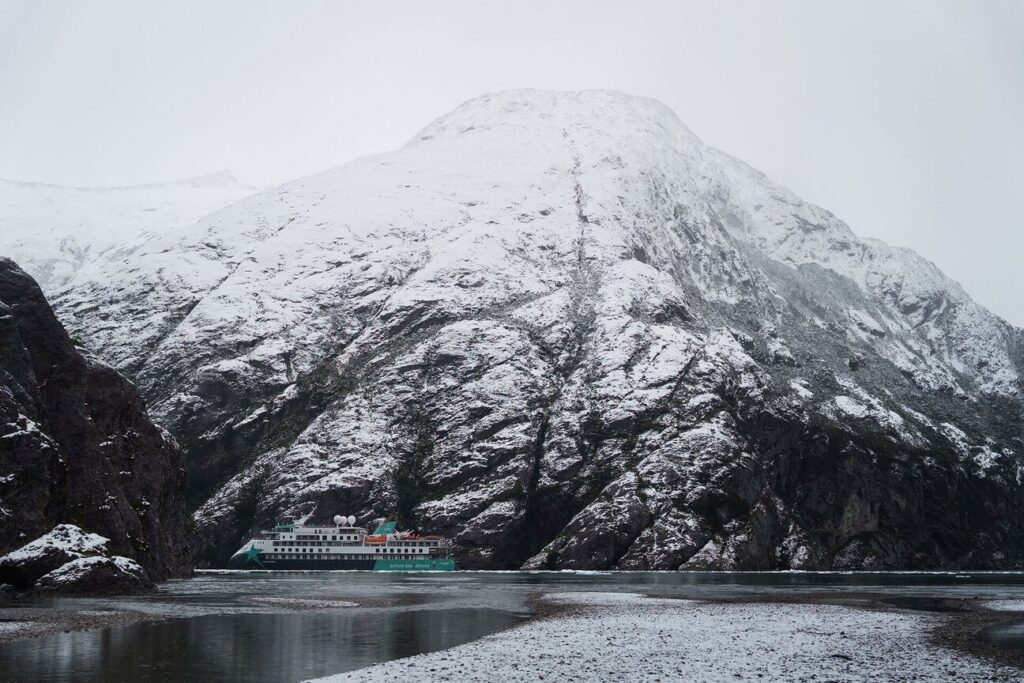 Snow-capped mountains above a Patagonian fjord