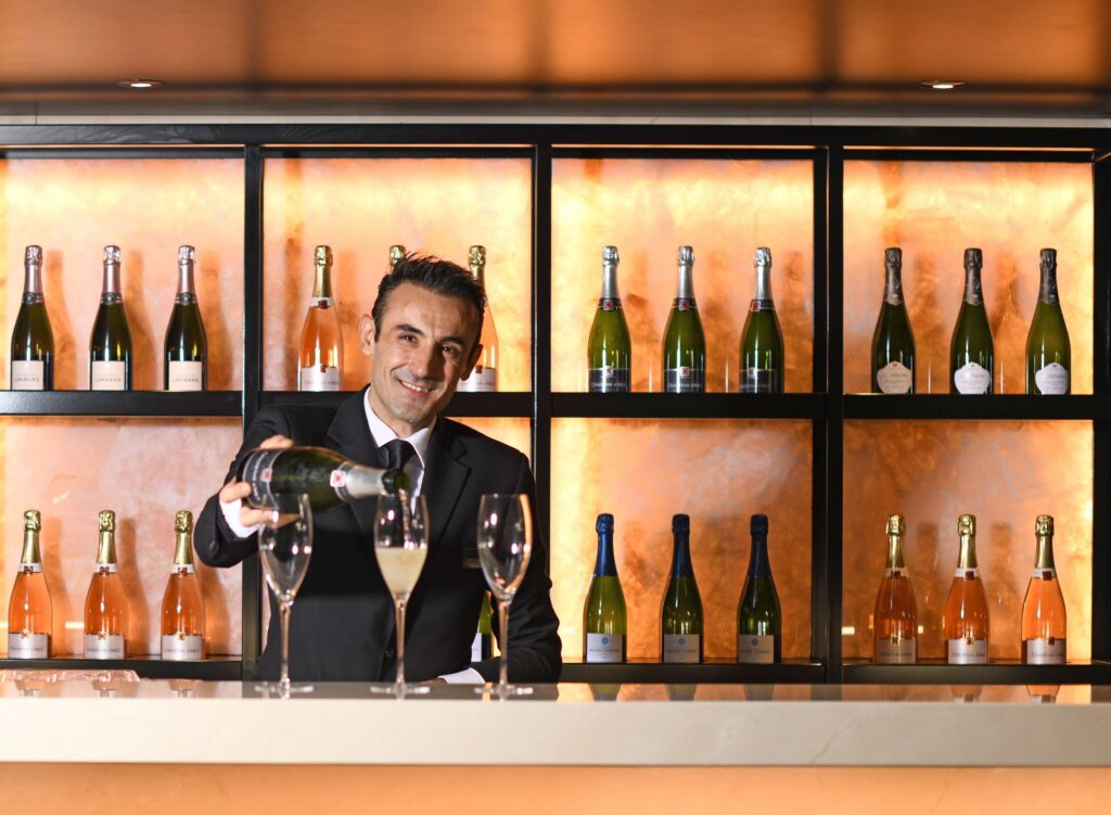 Sommelier at the Lumière Champagne Bar aboard Scenic Eclipse