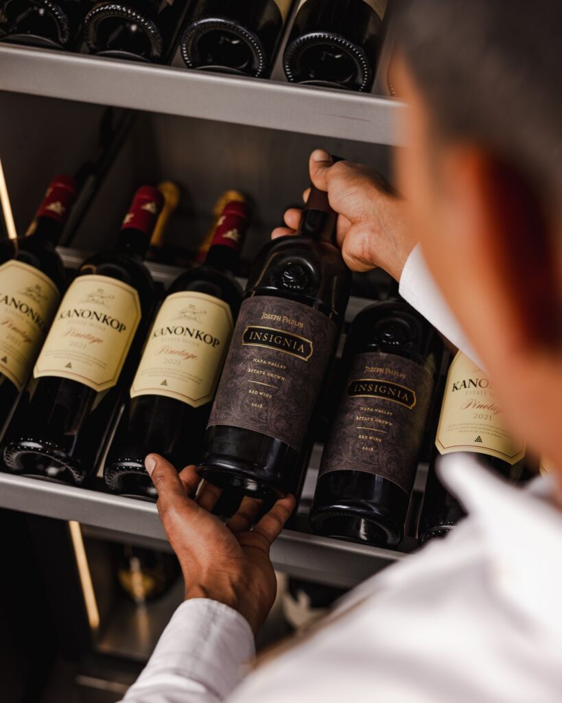 Sommelier presenting wine aboard Explora Journeys