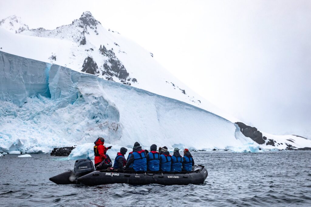 Zodiac cruising past glaciers at Orne Harbour, Antarctica